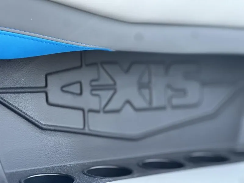 Slide: The Image of 2025 Axis A225 boat interior detail with logo and cup holders. - 10