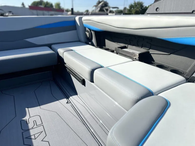 Slide: The Image of 2025 Axis A225 boat interior with gray and blue seating, showcasing modern design and comfort. - 11