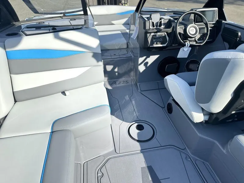 Slide: The Image of 2025 Axis A225 boat interior with modern seating and steering console. - 12