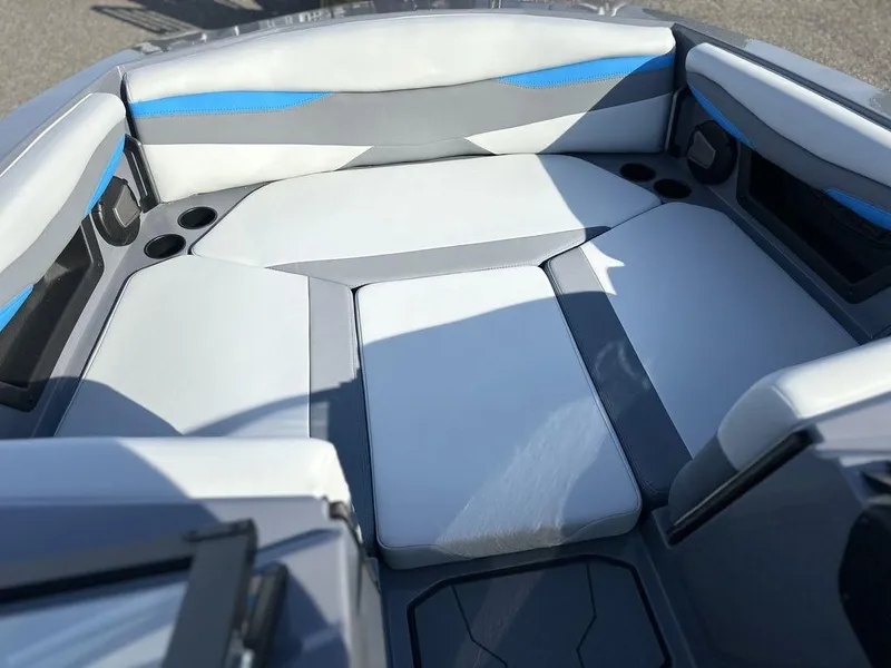 Slide: The Image of 2025 Axis A225 boat interior with gray and blue cushioned seating. - 15