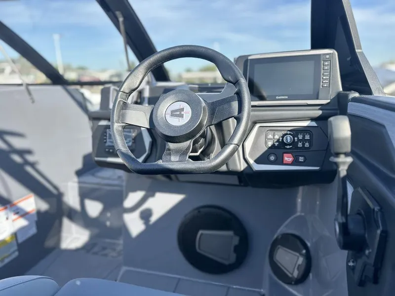 Slide: The Image of 2025 Axis A225 boat dashboard with steering wheel and control panel. - 19