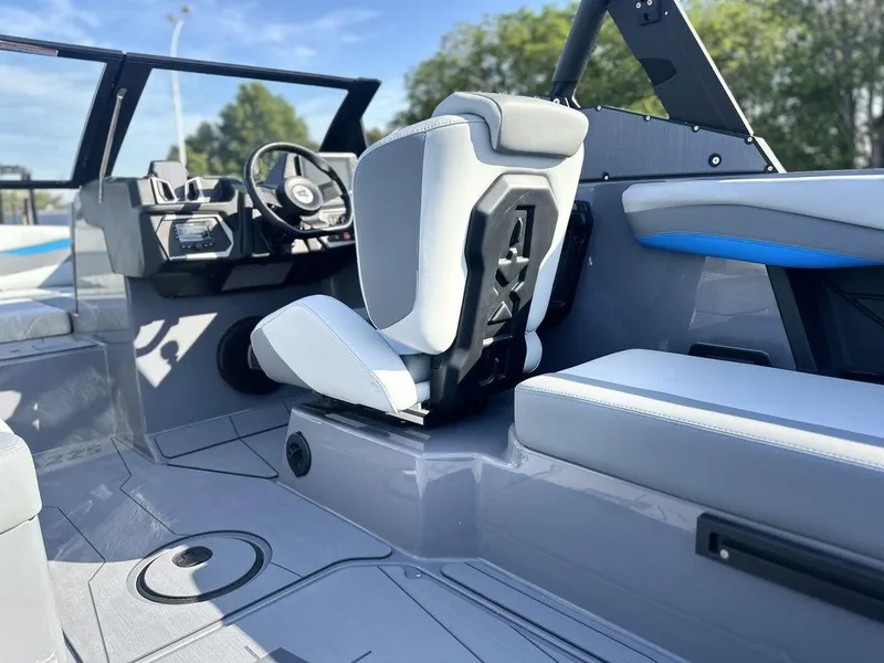 Slide: The Image of 2025 Axis A225 boat interior with modern seating and steering wheel. - 21