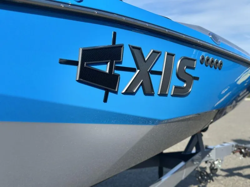 Slide: The Image of 2025 Axis A225 boat, blue exterior, close-up of logo on hull. - 23
