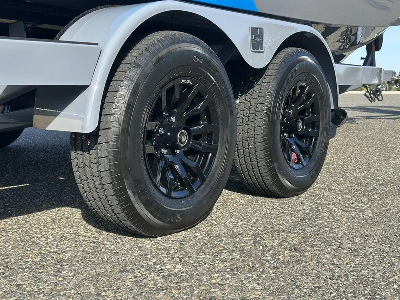 Slide: The Image of 2025 Axis A225 trailer with black alloy wheels on asphalt surface. - 3