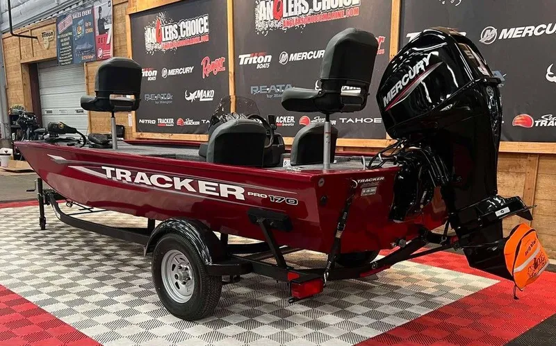Slide: The Image of 2025 Tracker Pro 170 boat with Mercury engine, displayed indoors on checkered flooring. - 3