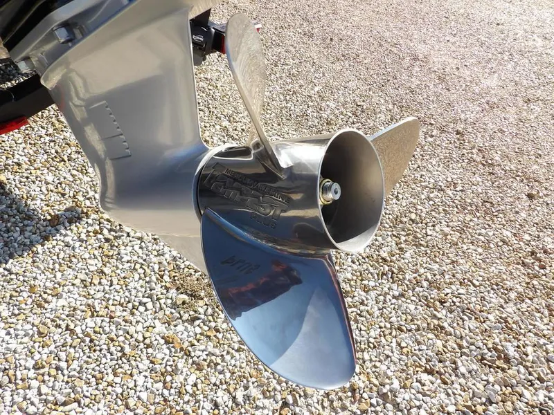 Slide: The Image of Propeller of 2025 Lund 1975 Renegade SS boat on gravel surface. - 2