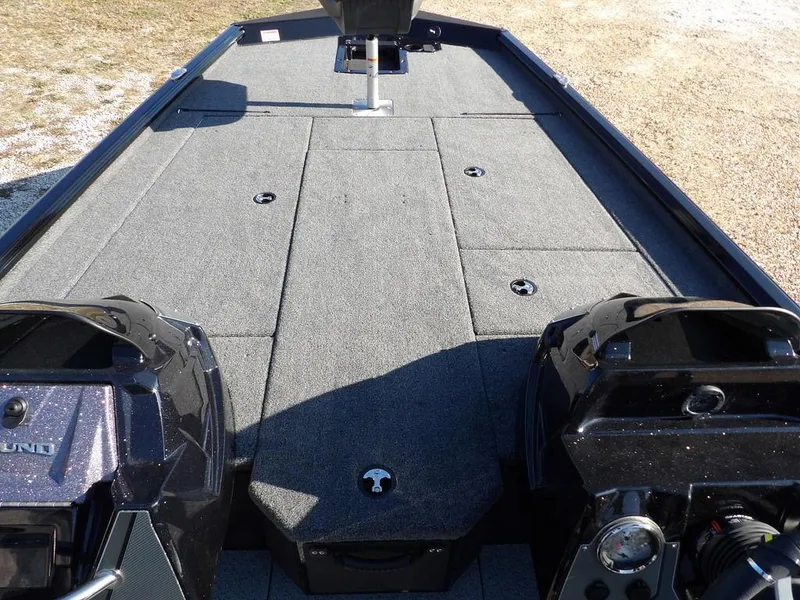 Slide: The Image of 2025 Lund 1975 Renegade SS boat interior with carpeted deck and dual engines. - 22