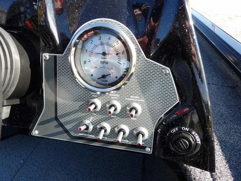Slide: The Image of Control panel of 2025 Lund 1975 Renegade SS boat with RPM gauge and switches. - 27