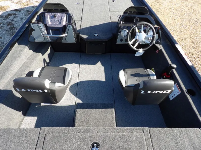 Slide: The Image of 2025 Lund 1975 Renegade SS boat interior with dual seats and steering console. - 31