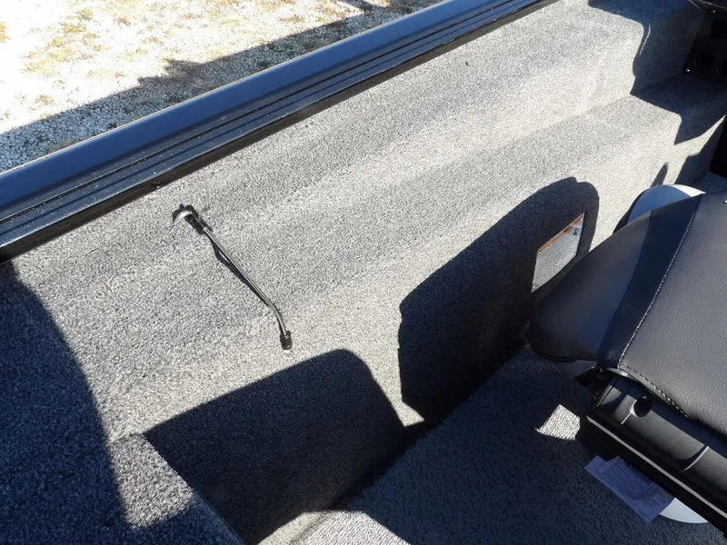 Slide: The Image of Interior of 2025 Lund 1975 Renegade SS boat, featuring gray carpet and seating. - 32