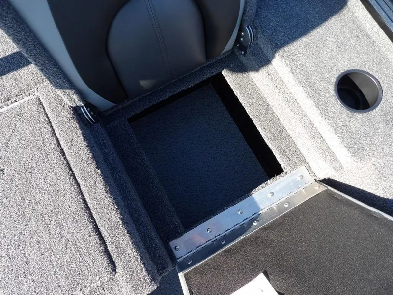 Slide: The Image of Interior view of 2025 Lund 1975 Renegade SS boat, featuring storage compartment and cup holder. - 33