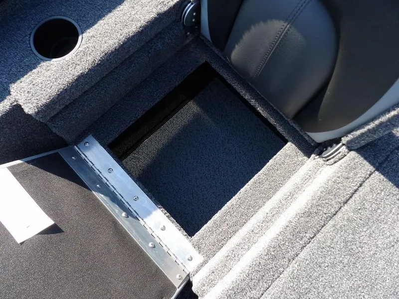 Slide: The Image of Interior view of 2025 Lund 1975 Renegade SS boat, featuring storage compartment and cup holder. - 37