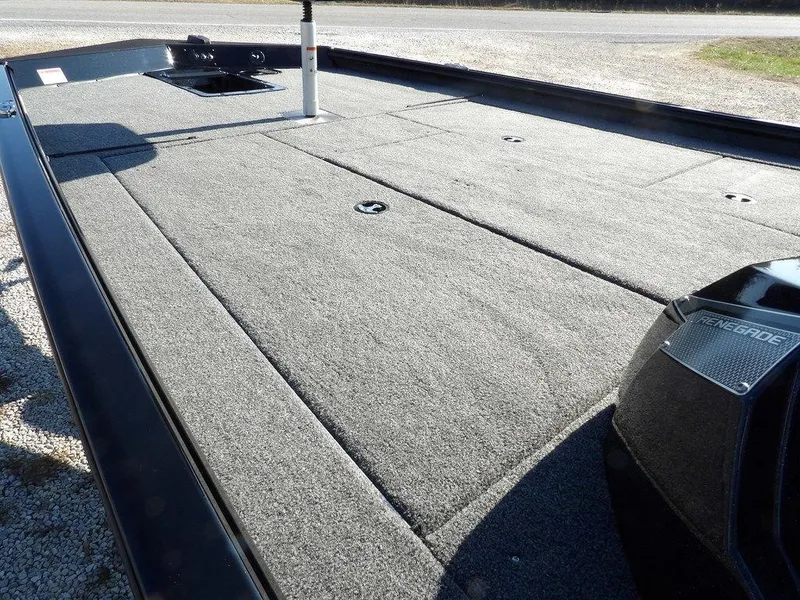 Slide: The Image of 2025 Lund 1975 Renegade SS boat deck with gray carpet and storage compartments. - 40