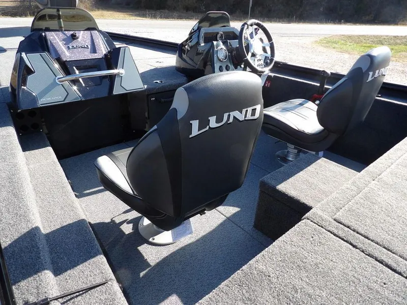 Slide: The Image of Interior of 2025 Lund 1975 Renegade SS boat with branded seats and steering console. - 41
