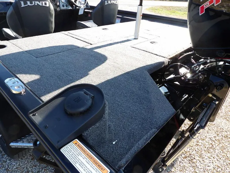 Slide: The Image of 2025 Lund 1975 Renegade SS boat deck with motor and seating area. - 42