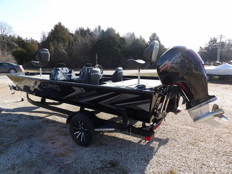 Slide: The Image of 2025 Lund 1975 Renegade SS boat with sleek design and powerful outboard motor. - 45