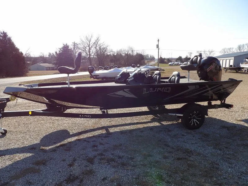 Slide: The Image of 2025 Lund 1975 Renegade SS boat on trailer, parked outdoors. - 47