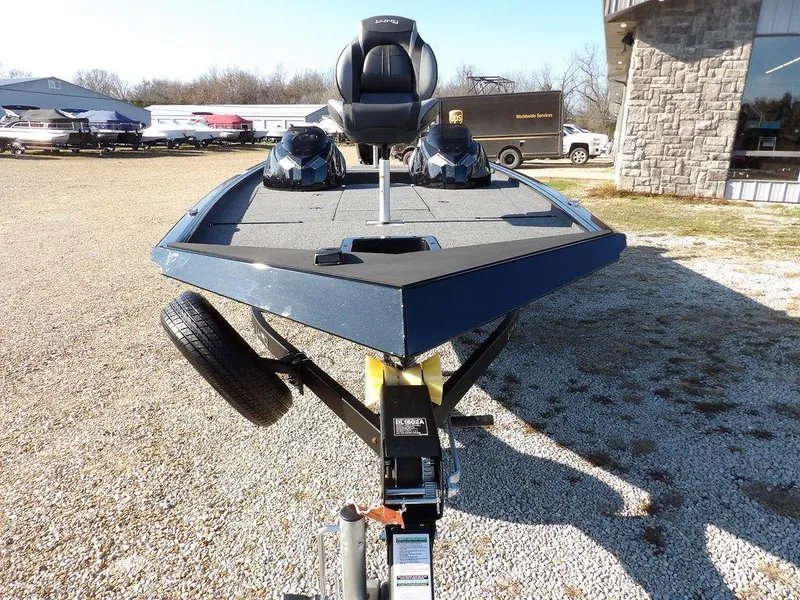 Slide: The Image of 2025 Lund 1975 Renegade SS boat on trailer, parked outdoors. - 48