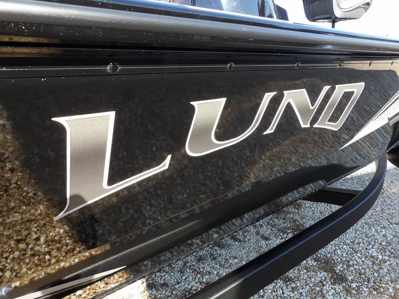 Slide: The Image of 2025 Lund 1975 Renegade SS boat with bold logo on sleek black exterior. - 6