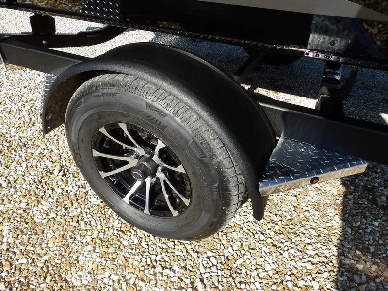 Slide: The Image of Trailer wheel of 2025 Lund 1975 Renegade SS on gravel surface. - 9