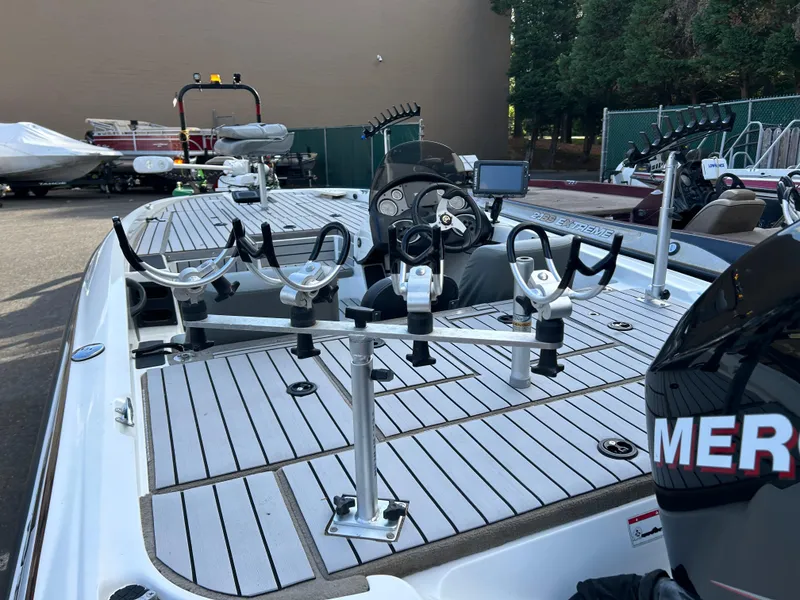 Slide: The Image of 2009 Triton 18 Explorer boat with fishing rod holders and steering console. - 7