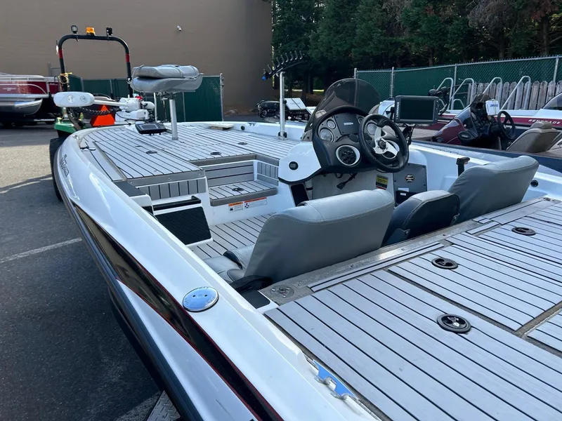 Slide: The Image of 2009 Triton 18 Explorer boat with spacious deck and modern controls. - 9