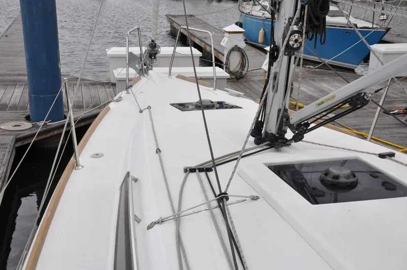 Slide: The Image of 2016 Jeanneau Sun Odyssey 349 sailboat docked at marina, showcasing deck and rigging. - 12