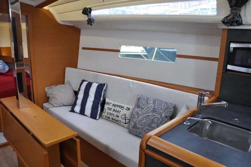Slide: The Image of Interior of 2016 Jeanneau Sun Odyssey 349 sailboat with cozy seating and kitchenette. - 25