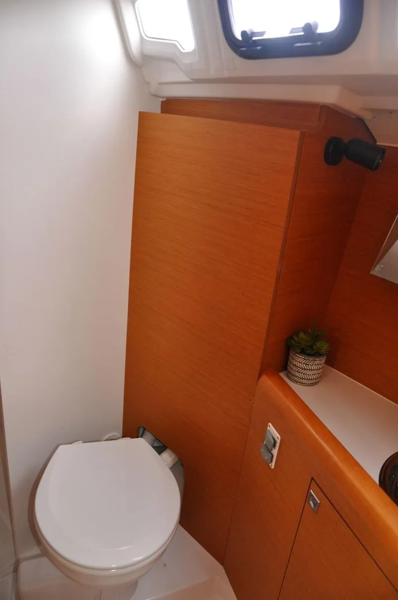 Slide: The Image of 2016 Jeanneau Sun Odyssey 349 bathroom with wooden cabinetry and compact design. - 29