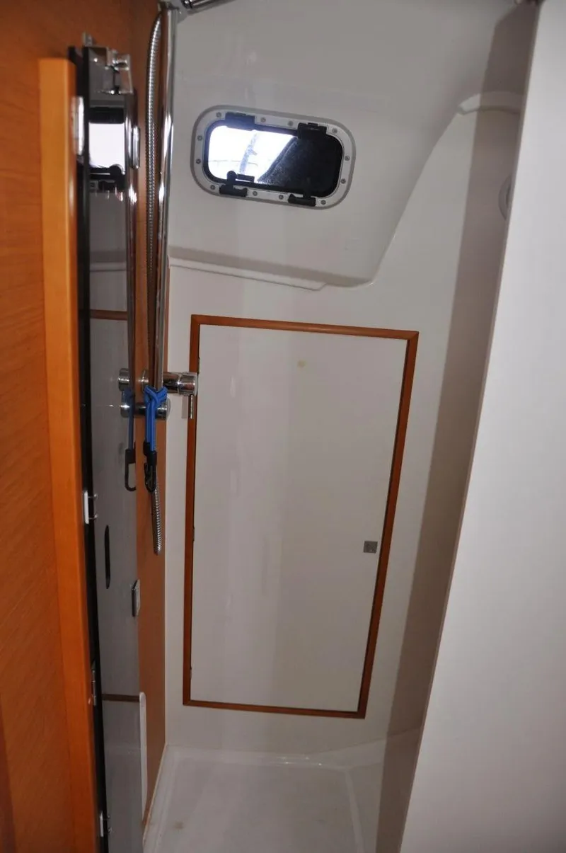Slide: The Image of 2016 Jeanneau Sun Odyssey 349 yacht bathroom with shower and porthole window. - 30