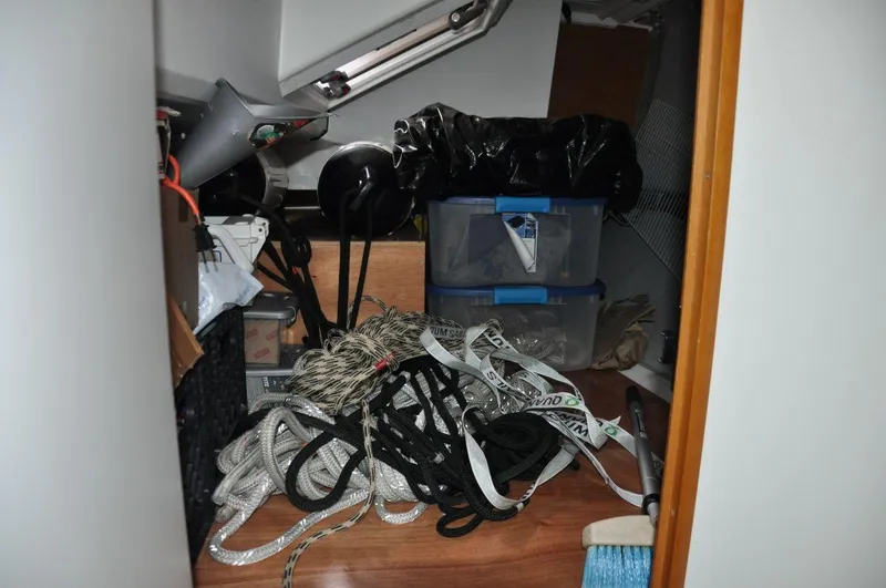 Slide: The Image of Storage area in a 2016 Jeanneau Sun Odyssey 349 sailboat with ropes and containers. - 31