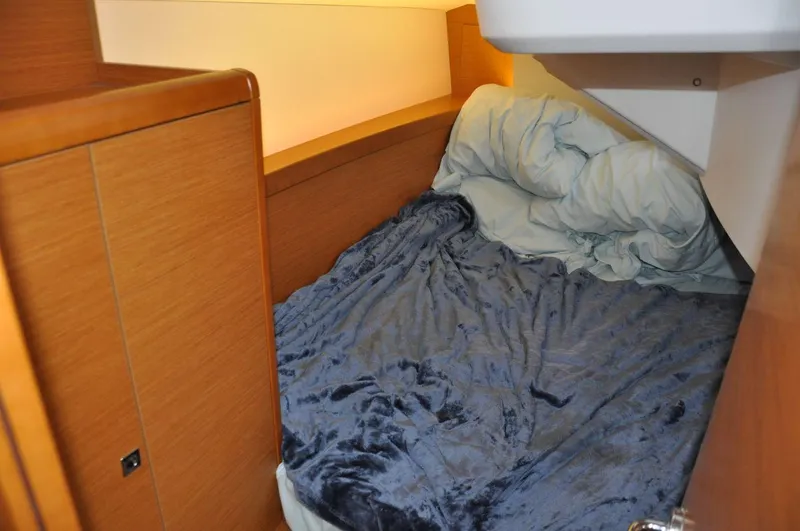 Slide: The Image of Cozy cabin interior of 2016 Jeanneau Sun Odyssey 349 sailboat with plush bedding. - 32
