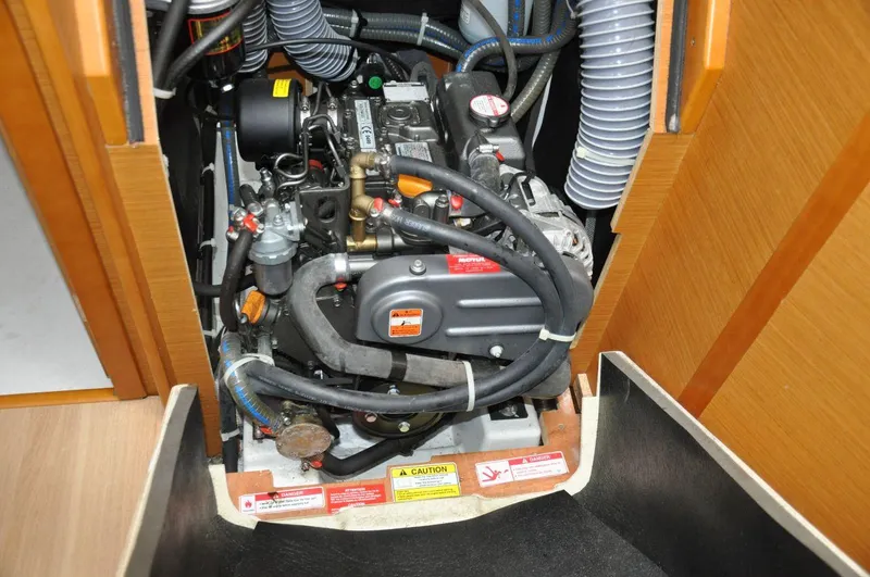 Slide: The Image of Engine compartment of a 2016 Jeanneau Sun Odyssey 349 sailboat, showcasing mechanical components. - 33