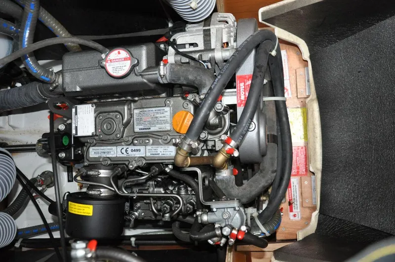 Slide: The Image of Engine compartment of a 2016 Jeanneau Sun Odyssey 349 sailboat, showcasing detailed mechanical components. - 34