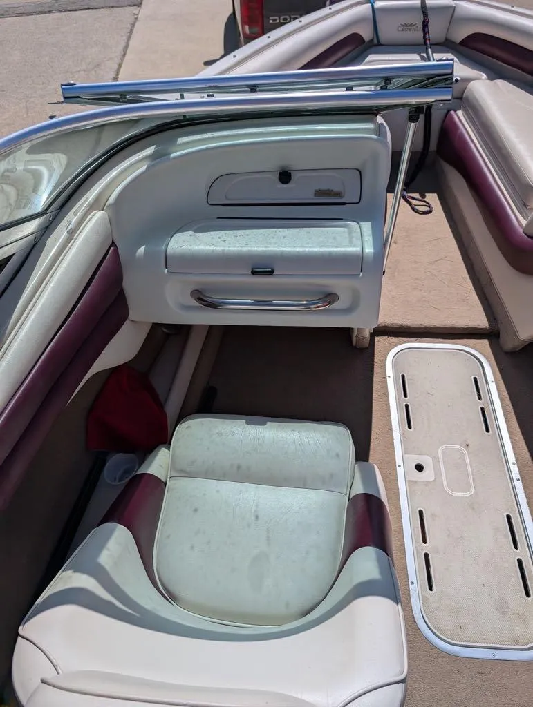 Slide: The Image of Interior of a 1995 Crownline 182 BR boat with white and maroon seating. - 7