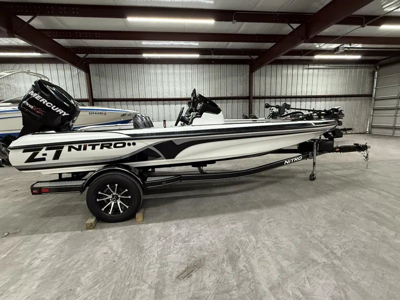 Slide: The Image of 2011 Nitro Z-7 boat in a warehouse, featuring a sleek design and Mercury engine. - 1
