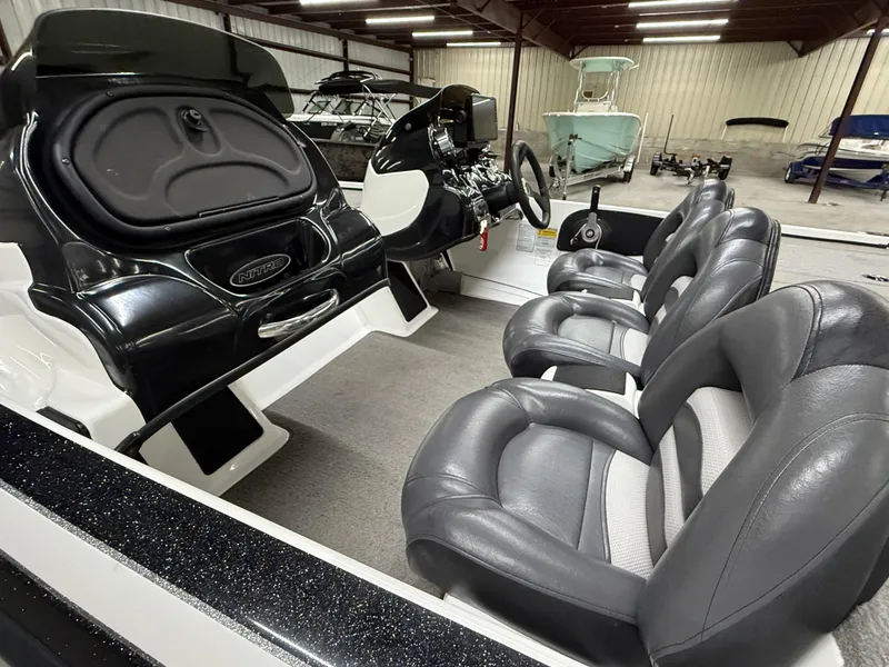 Slide: The Image of Interior of a 2011 Nitro Z-7 boat with sleek black and gray seating. - 13