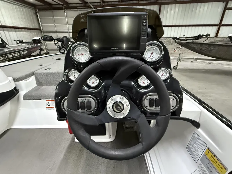 Slide: The Image of Steering console of a 2011 Nitro Z-7 boat with gauges and a Garmin display. - 14
