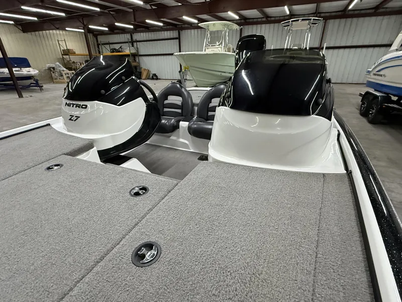 Slide: The Image of 2011 Nitro Z-7 boat interior with dual seats in a storage facility. - 7
