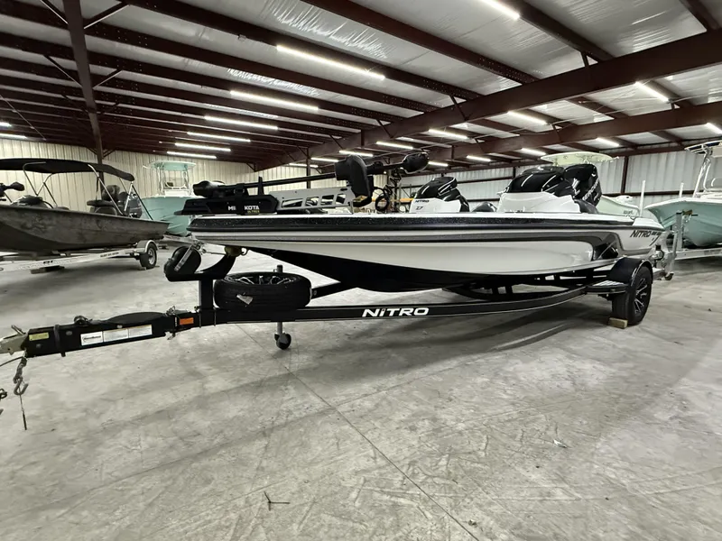 Slide: The Image of 2011 Nitro Z-7 boat in a warehouse, on a trailer, with visible equipment. - 9