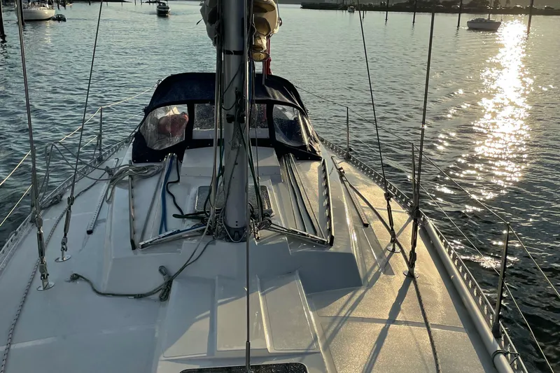 Slide: The Image of 1985 Contest 36S sailboat on calm water at sunset. - 13