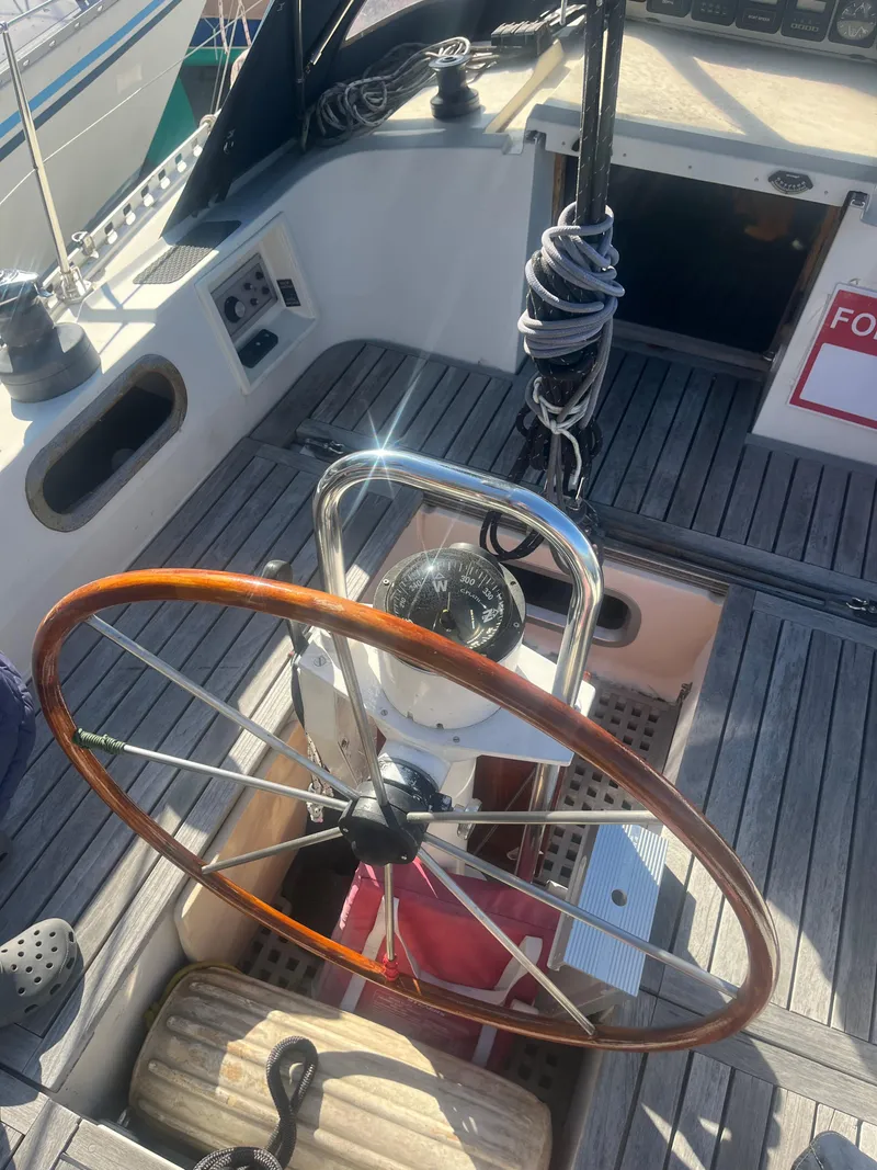 Slide: The Image of Cockpit of 1985 Contest 36S sailboat with wooden steering wheel and nautical equipment. - 16