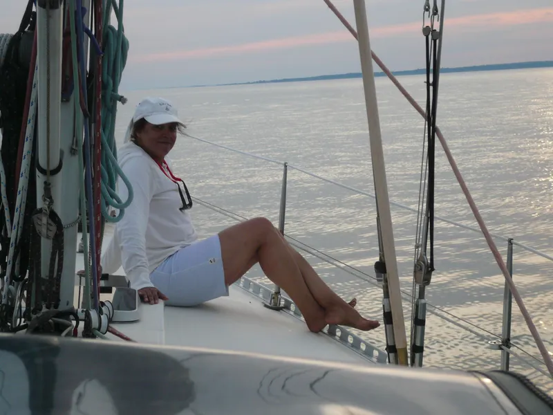 Slide: The Image of Woman relaxing on a 1985 Contest 36S sailboat at sunset. - 25