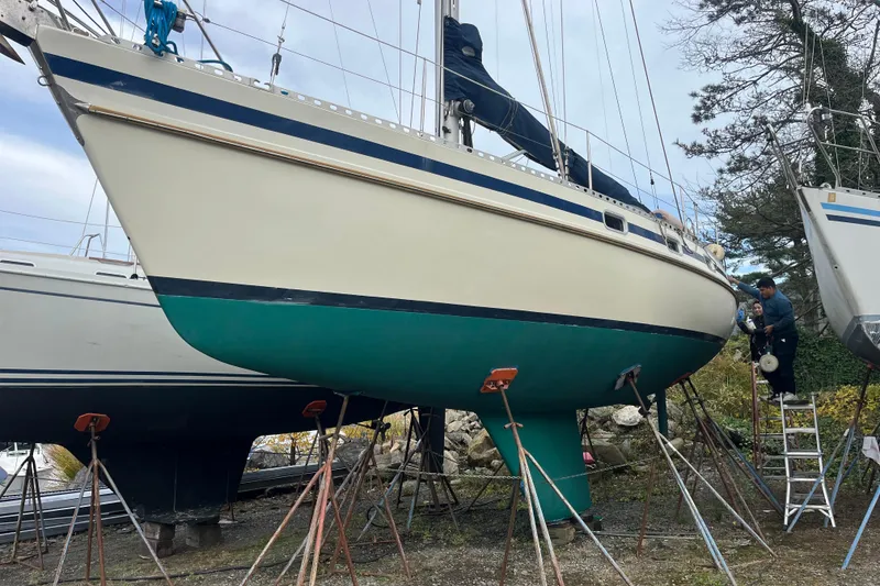 Slide: The Image of 1985 Contest 36S sailboat on stands, undergoing maintenance in a boatyard. - 26