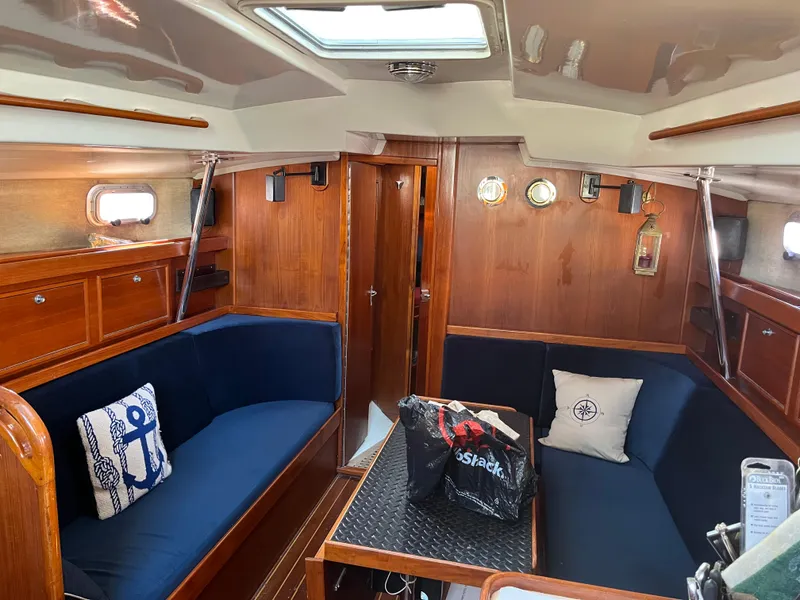 Slide: The Image of Interior of 1985 Contest 36S sailboat with wooden finish and blue seating. - 3