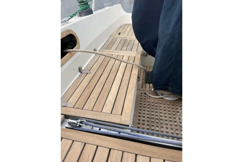 Slide: The Image of 1985 Contest 36S sailboat deck with wooden flooring and nautical equipment. - 31