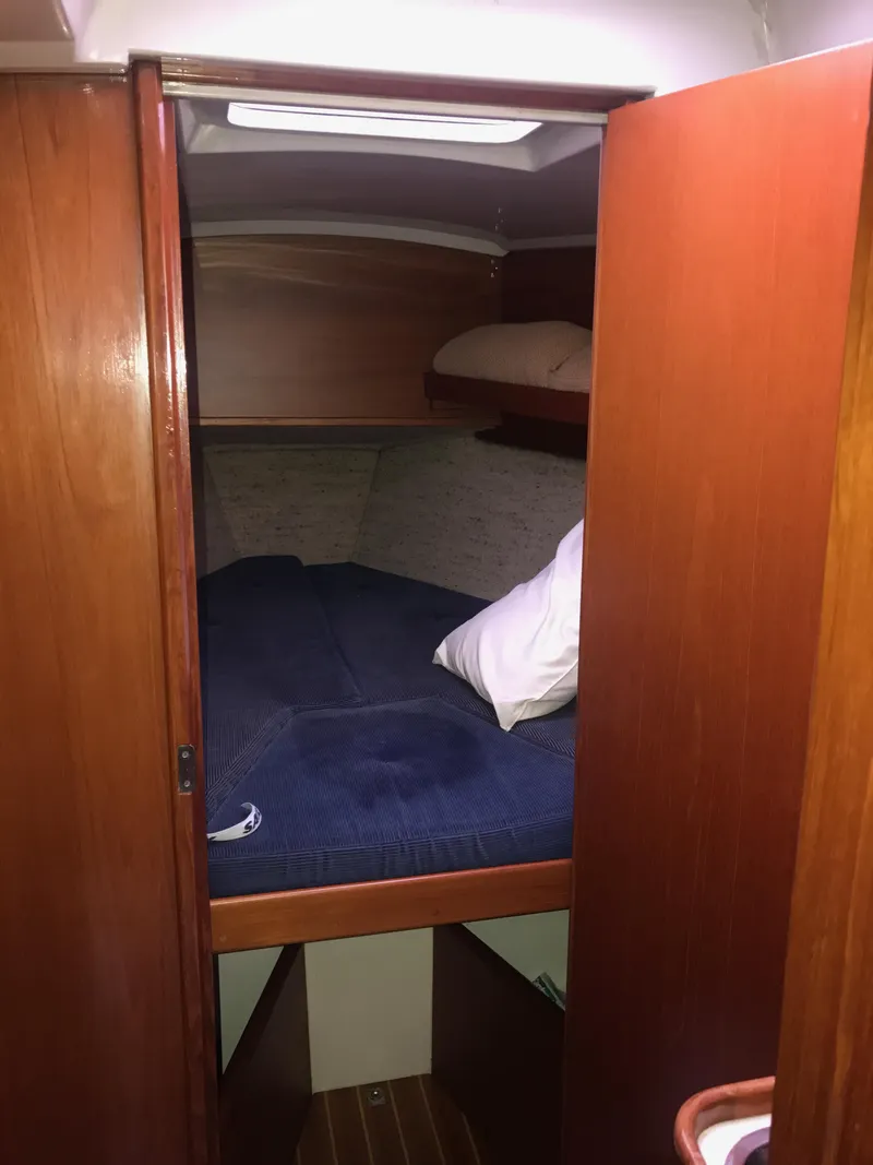 Slide: The Image of 1985 Contest 36S yacht cabin with cozy bed and wooden interior. - 9