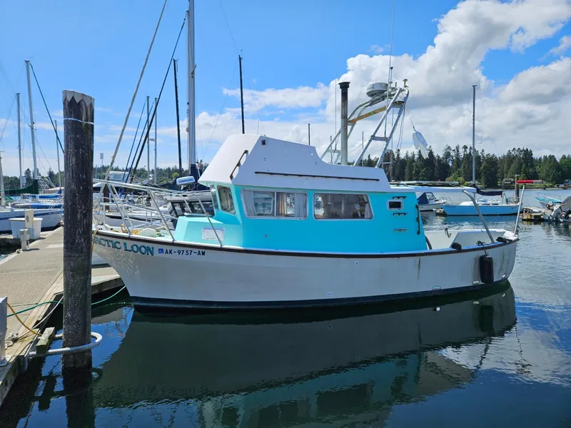 The Image of 1975 Monterey Diesel Cruiser Trawler docked at marina under blue sky. - 0