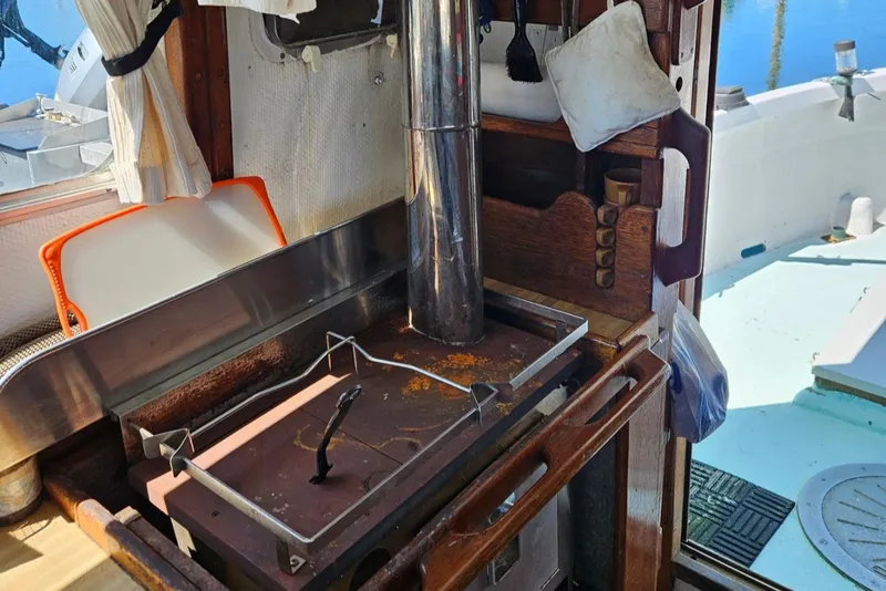 Slide: The Image of 1975 Trawler Monterey Diesel Cruiser interior with stove and nautical decor. - 11