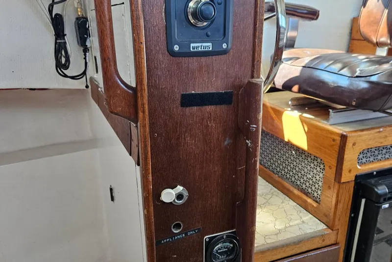 Slide: The Image of 1975 Trawler Monterey Diesel Cruiser interior with wooden paneling and control features. - 14